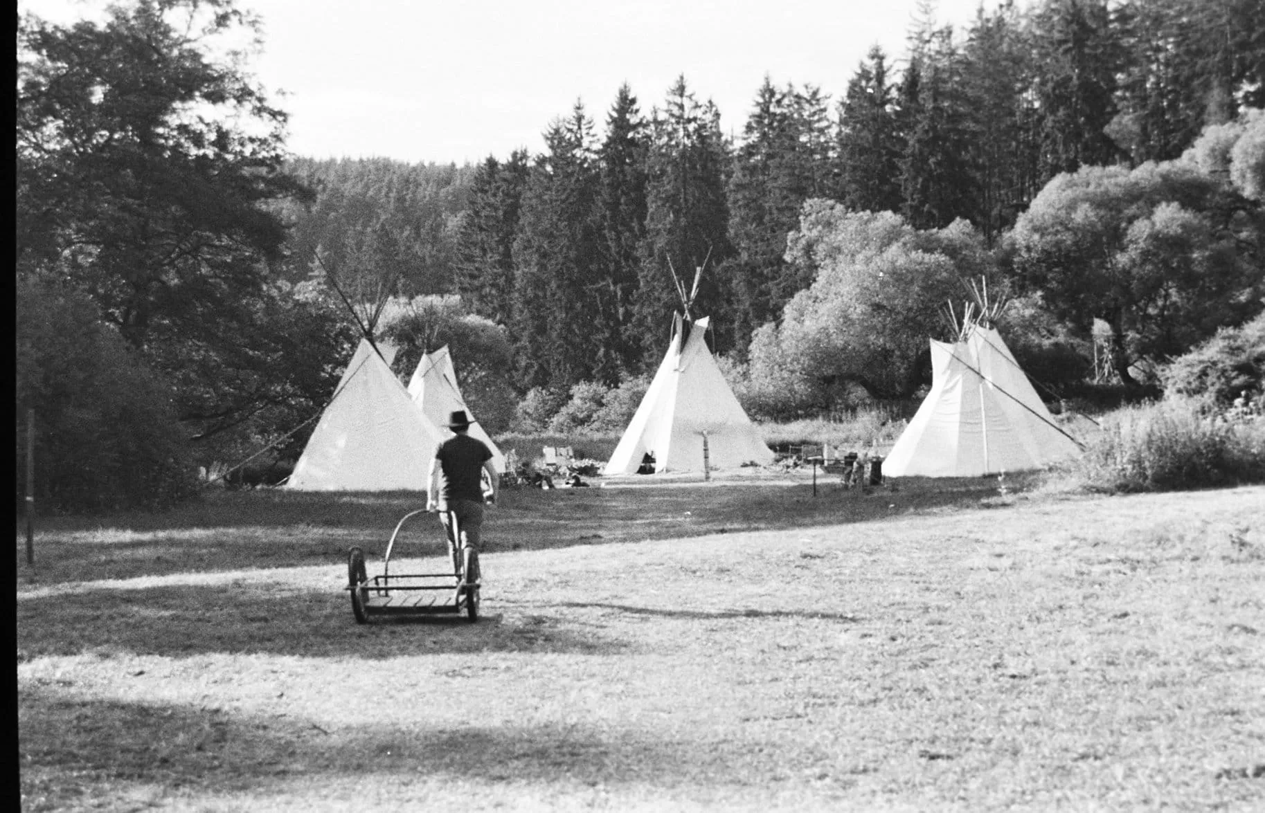 Grayscale photo of teepees